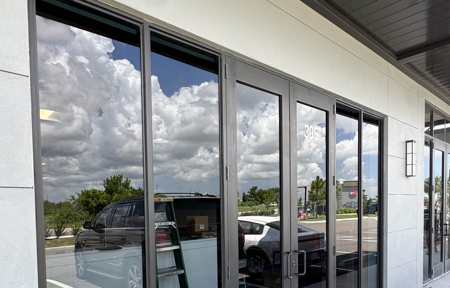 Clean commercial storefront glass and entry doors at a Cape Coral plaza