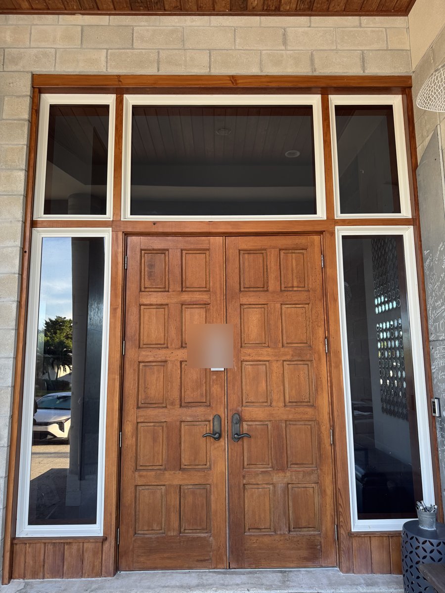 Cleaned entry doors and sidelight glass on a Fort Myers home, rich wood detail